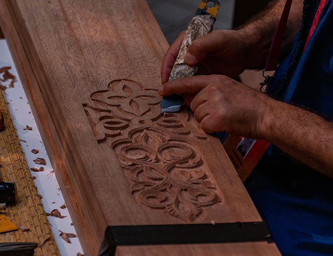 Image of hand-carving intricate wooden design displayed on the Sanatkada About Us page
