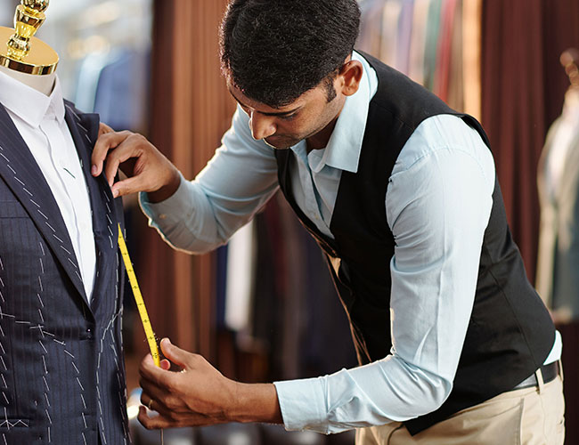 A men measuring a suit on a mannequin image on the Sanatkada Darzi page